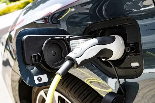 Aptera Motors Nasdaq-Listing – Elektroauto an Ladestation Ladekabel steckt im Ladeanschluss eines Elektroautos, passend zum Börsengang von Aptera Motors an der Nasdaq